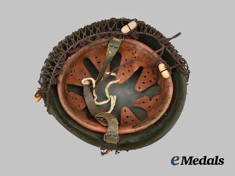 italy,_kingdom._an_m33_steel_helmet,_owner-_attributed,_with_net___m_n_c0063