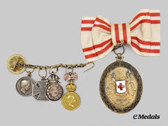 Austria, Imperial. A Ladies Honour Decoration of the Red Cross, and Miniature Chain of Decorations