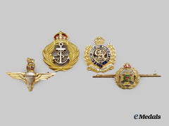 United Kingdom. Four Military Service Badges in 9 Kt. Gold