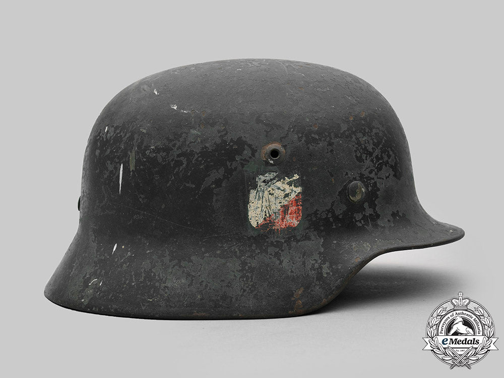 germany,_heer._a_battle-_damaged_heer_m40_steel_helmet_c2020_474_mnc9353_1_1_1_1_1