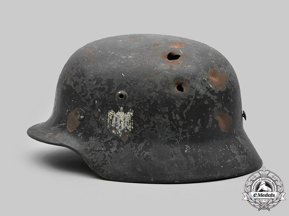 germany,_heer._a_battle-_damaged_heer_m40_steel_helmet_c2020_476_mnc9815_1_1_1_1_1
