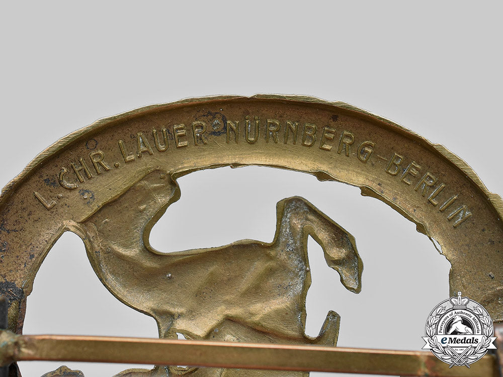 germany,_third_reich._a_german_equestrian_badge,_iii_class_in_bronze,_by_l._christian_lauer_c2021_751_mnc6623