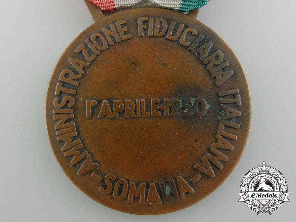 an_italian_medal_for_financial_advisor_to_somalia1950_bronze,32_mm,_original_ribbon,_oxidation_spots_on_the_reverse,_light_contact,_very_fine._c_3552