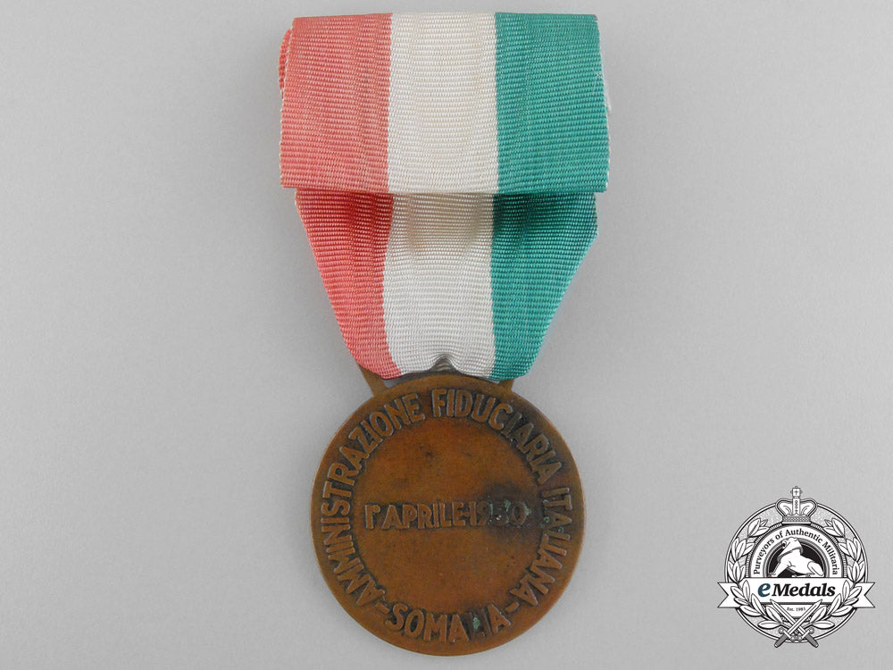 an_italian_medal_for_financial_advisor_to_somalia1950_bronze,32_mm,_original_ribbon,_oxidation_spots_on_the_reverse,_light_contact,_very_fine._c_3553