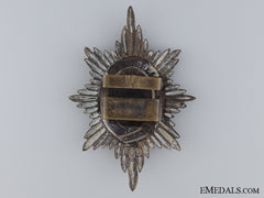 A Worchestershire Brass Puggaree Badge