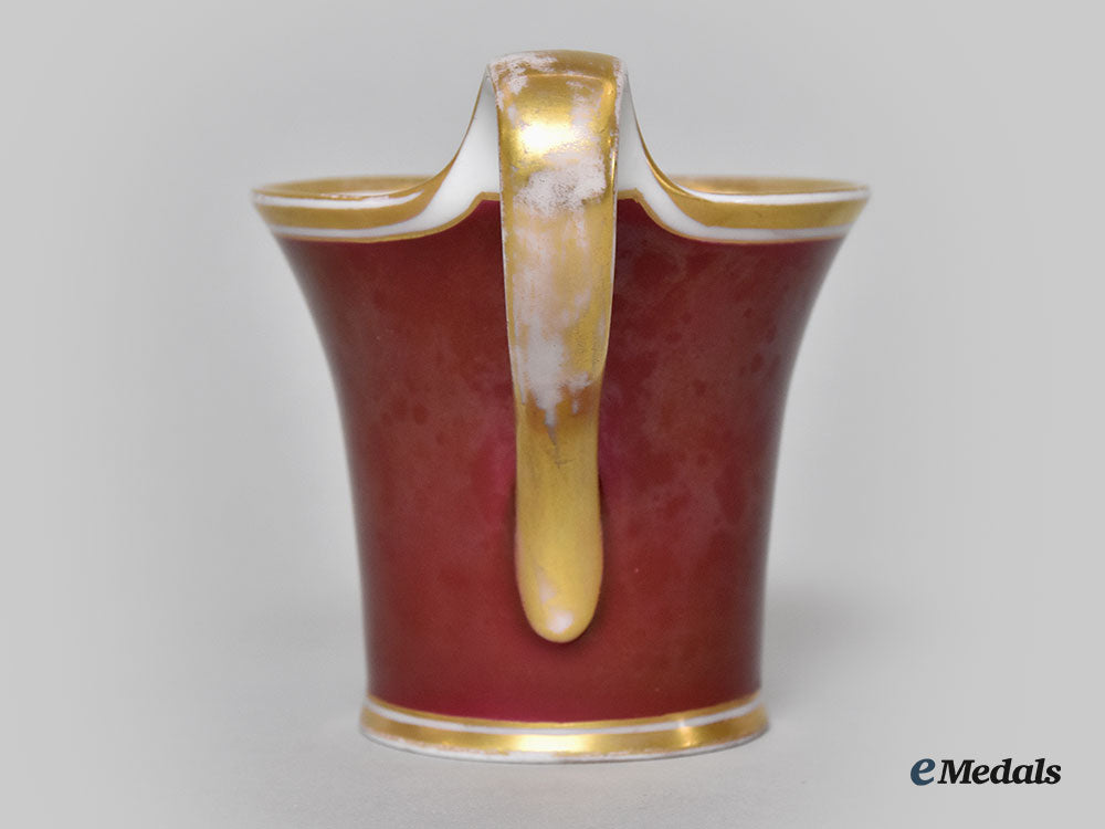 germany,_imperial._a_red_glazed_porcelain_iron_cross_mug,_by_furstenberg_l22_mnc9150_393_1