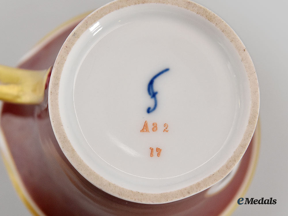 germany,_imperial._a_red_glazed_porcelain_iron_cross_mug,_by_furstenberg_l22_mnc9156_390_1