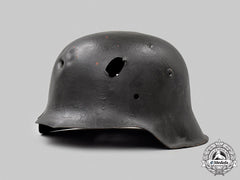 Germany, Heer. A Battle-Damaged M42 Stahlhelm