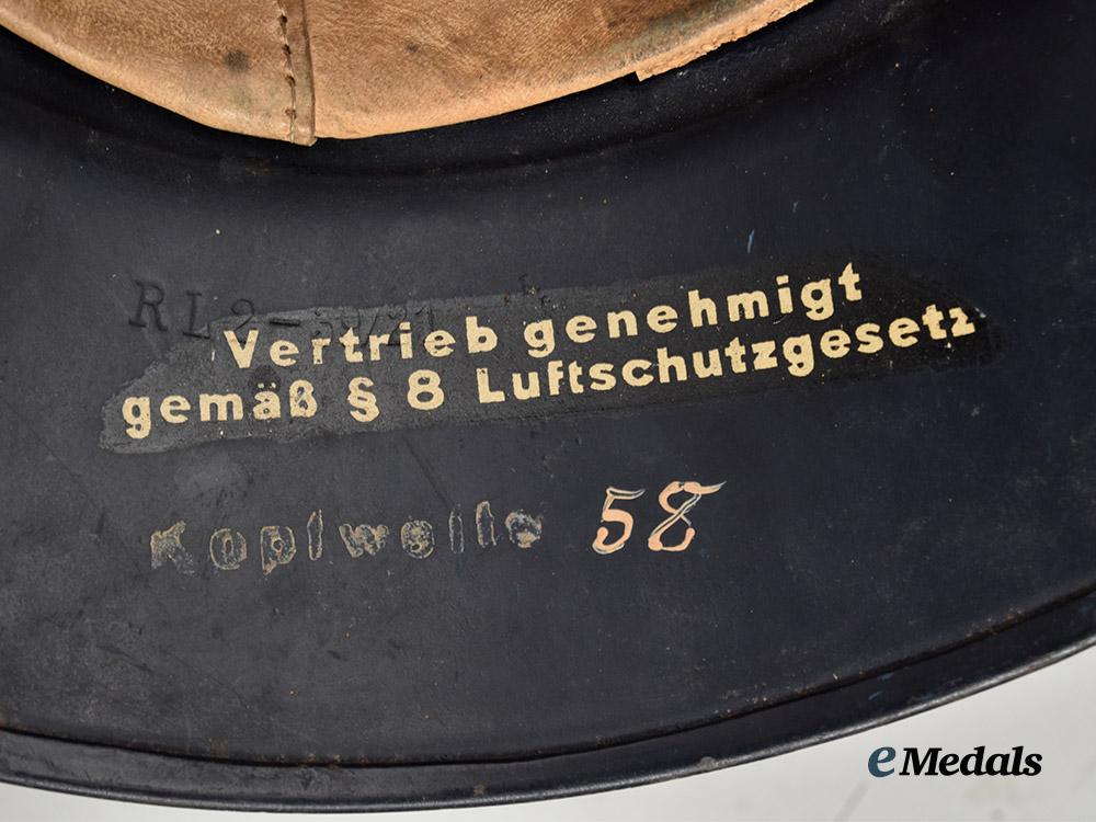 germany,_third_reich._a_luftschutz_gladiator_helmet,_owner-_attributed_one-_piece_version,_by_f._w._quist___m_n_c0145