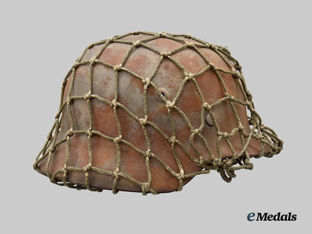 germany,_heer._an_m40_stahlhelm,_with_field-_added_camouflage_netting___m_n_c4997