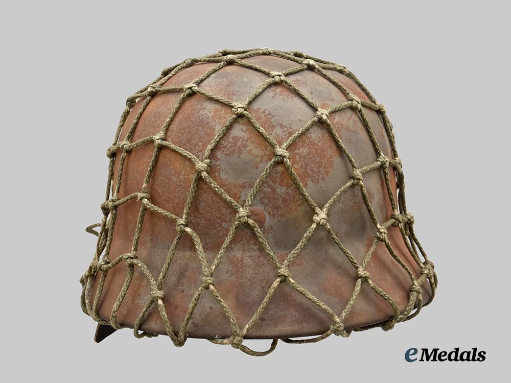 germany,_heer._an_m40_stahlhelm,_with_field-_added_camouflage_netting___m_n_c4999