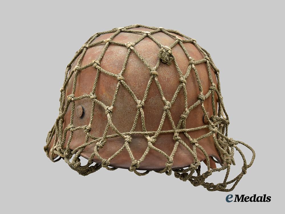 germany,_heer._an_m40_stahlhelm,_with_field-_added_camouflage_netting___m_n_c5000