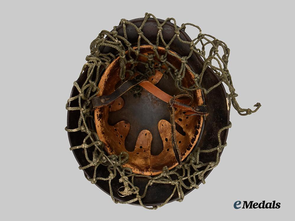 germany,_heer._an_m40_stahlhelm,_with_field-_added_camouflage_netting___m_n_c5003