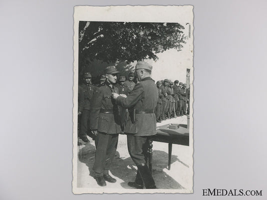 a_period_photograph;_croatian_officer_awarding_ustasa_troops_a_period_photogr_546b6a4c022bc