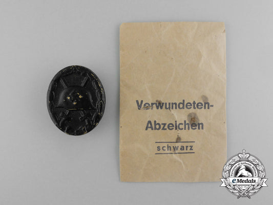 a_second_war_german_black_grade_wound_badge;_tombac_version_in_its_packet_of_issue_aa_1205