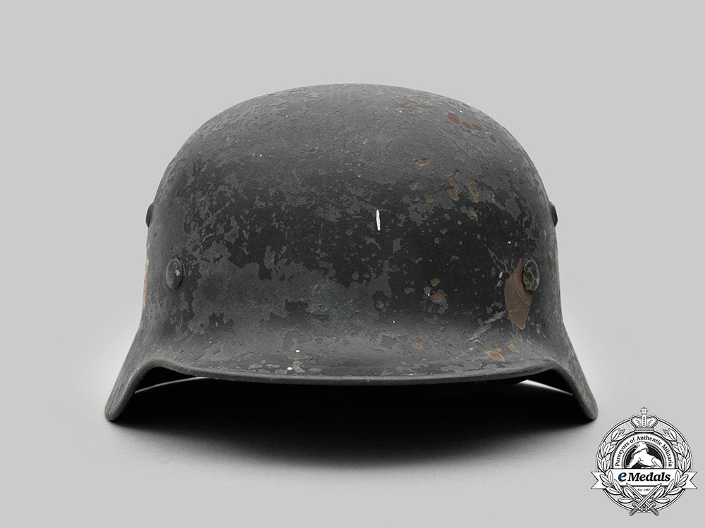 germany,_heer._a_battle-_damaged_heer_m40_steel_helmet_c2020_473_mnc9351_1_1_1_1_1