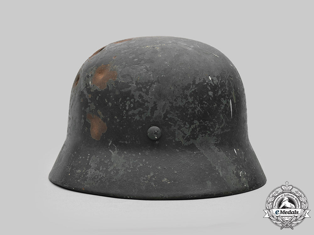 germany,_heer._a_battle-_damaged_heer_m40_steel_helmet_c2020_475_mnc9355_1_1_1_1_1