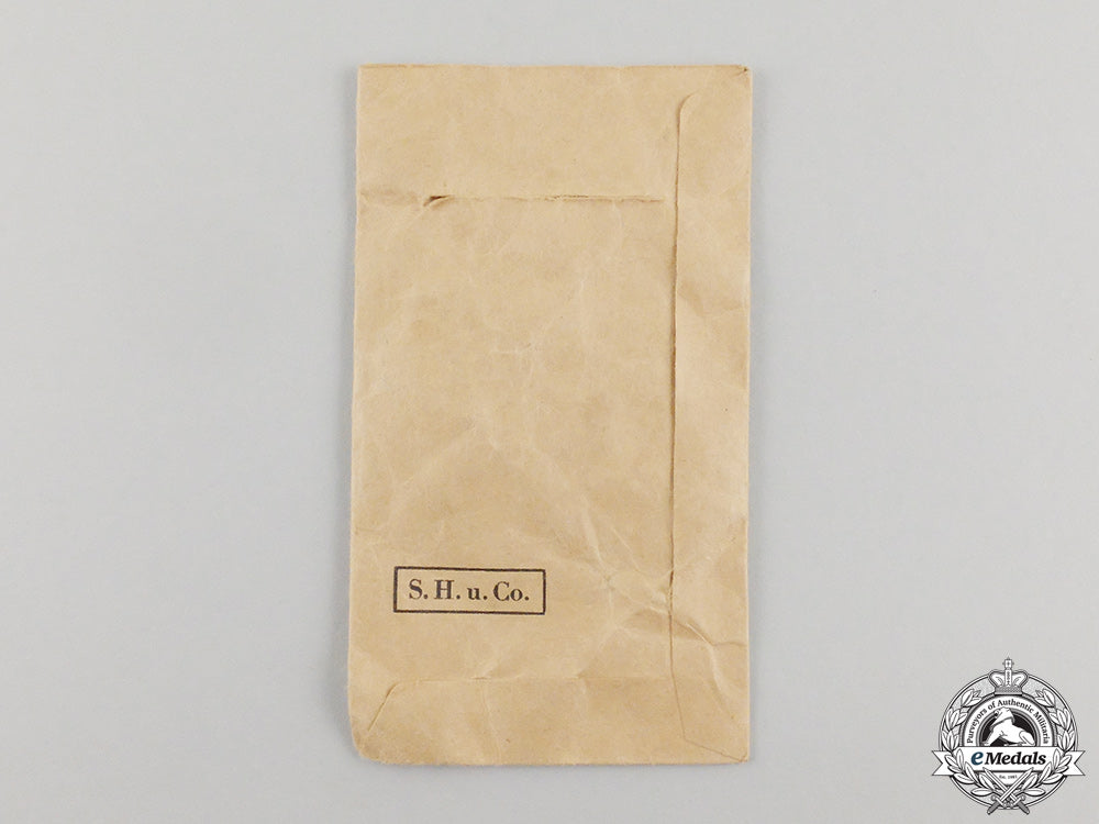 germany,_kriegsmarine._a_coastal_artillery_war_badge_by_sohni&_heubach_in_packet_of_issue_cc_1210