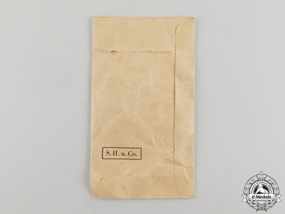 germany,_kriegsmarine._a_coastal_artillery_war_badge_by_sohni&_heubach_in_packet_of_issue_cc_1210