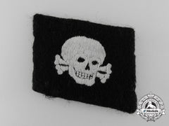 An Ss Totenkopf Skull Collar Tab; "Pumpkin Head Pattern"