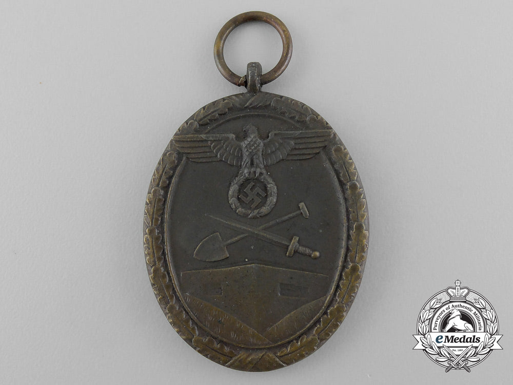 a_second_war_west_wall_medal_with_packet_of_issue_by_carl_poellath_of_schrobenhausen_d_7637