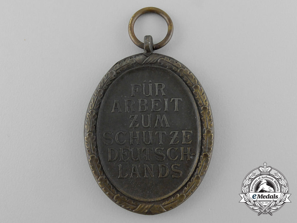 a_second_war_west_wall_medal_with_packet_of_issue_by_carl_poellath_of_schrobenhausen_d_7638_1