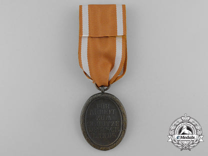 a_second_war_west_wall_medal_with_packet_of_issue_by_carl_poellath_of_schrobenhausen_d_7639_1