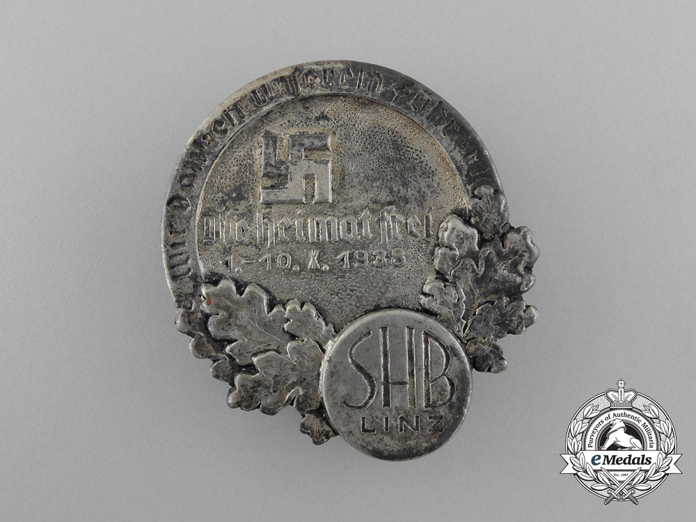 germany,_nsdap._a1938_linz“_we_thank_our_führer-_our_homeland_is_free”_badge_d_8977_1