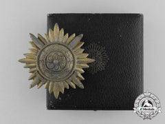 A First Class Ostvolk Bravery Decoration; Gold Grade With Swords & Case