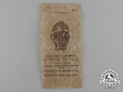a_german-_italian_africa_campaign_medal_with_its_original_packet_of_issue_by_lorioli_fratelli_d_9454_1