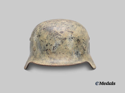 germany,_wehrmacht._an_m35_stahlhelm_with_field-_applied_winter_camouflage,_by_f._w._quist_e_medals__g61230_2