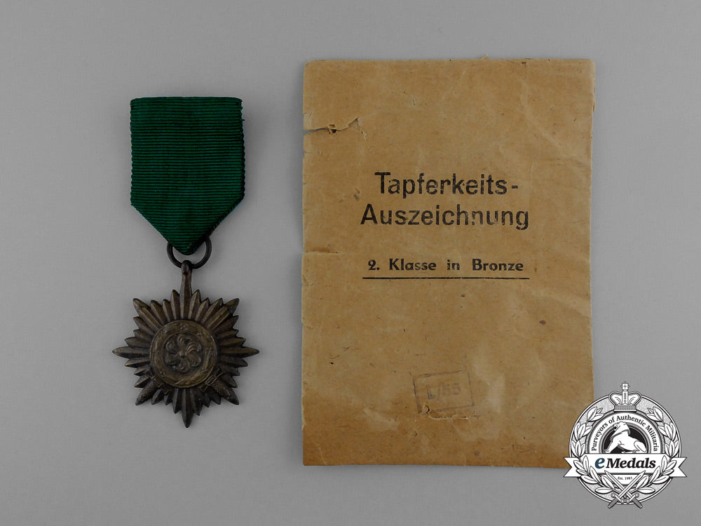 a_bronze_grade_ostvolk_merit_medal_with_swords_in_its_original_packet_of_issue_by_rudolf_wächtler&_lange_e_0047