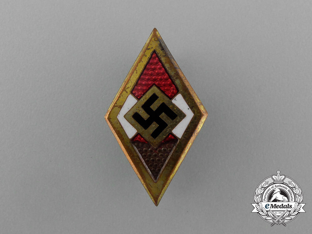 a_golden_hj_member’s_honour_badge;_numbered_e_2082