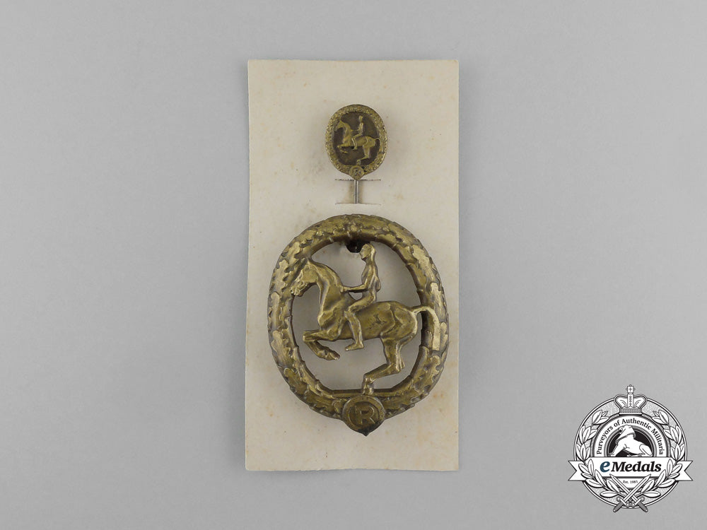a_mint_second_war_german_bronze_grade_equestrian_badge_and_stick_pin_on_its_display_board_e_6271