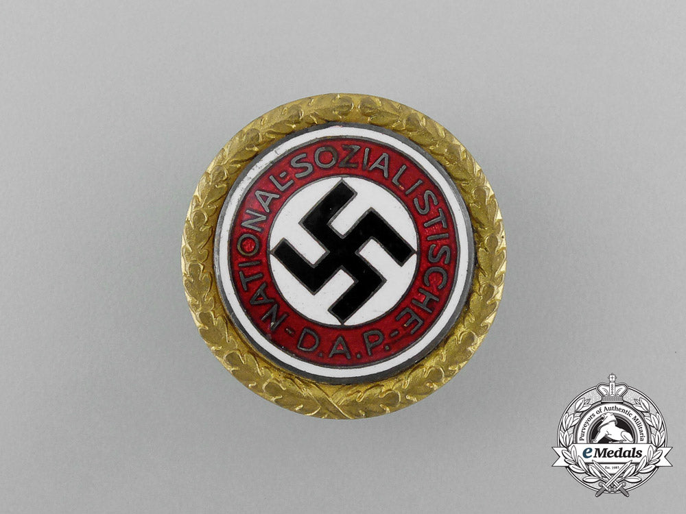 a_large_golden_party_badge_with_documents_to_wehrmacht_gefreiter_reimann_e_6547