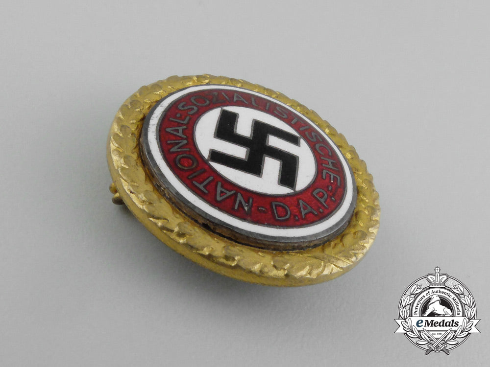 a_large_golden_party_badge_with_documents_to_wehrmacht_gefreiter_reimann_e_6549