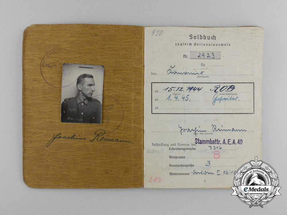 a_large_golden_party_badge_with_documents_to_wehrmacht_gefreiter_reimann_e_6552