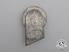 A 1934 Oberursel Day Of The Homeland And Volks Announcement Badge