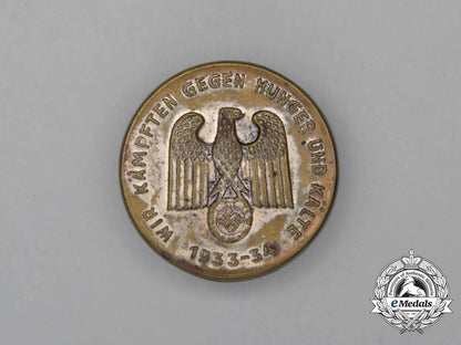 a1933/34_whw“_we_are_fighting_against_hunger_and_the_cold”_badge_h_616_1