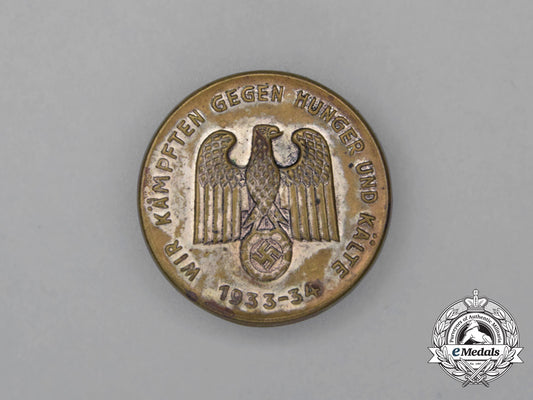 a1933/34_whw“_we_are_fighting_against_hunger_and_the_cold”_badge_h_616_1
