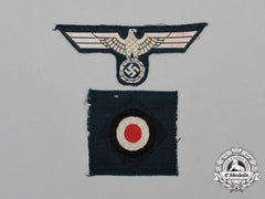 A Set Of German Wehrmacht Overseas Cap Insignia