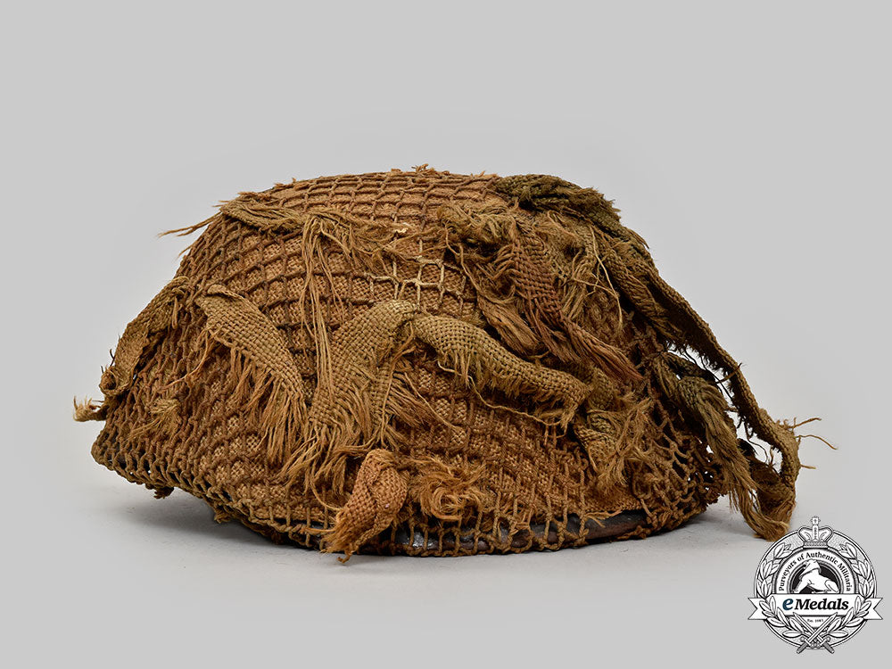 germany,_wehrmacht._an_m42_stahlhelm,_with_netting_and_hessian_cloth_cover_l22_mnc0045_924