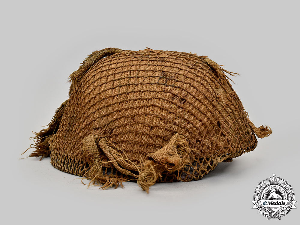 germany,_wehrmacht._an_m42_stahlhelm,_with_netting_and_hessian_cloth_cover_l22_mnc0046_925