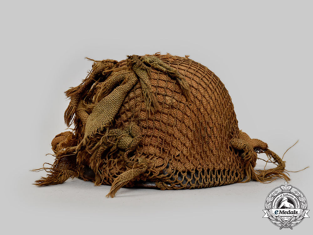 germany,_wehrmacht._an_m42_stahlhelm,_with_netting_and_hessian_cloth_cover_l22_mnc0047_926