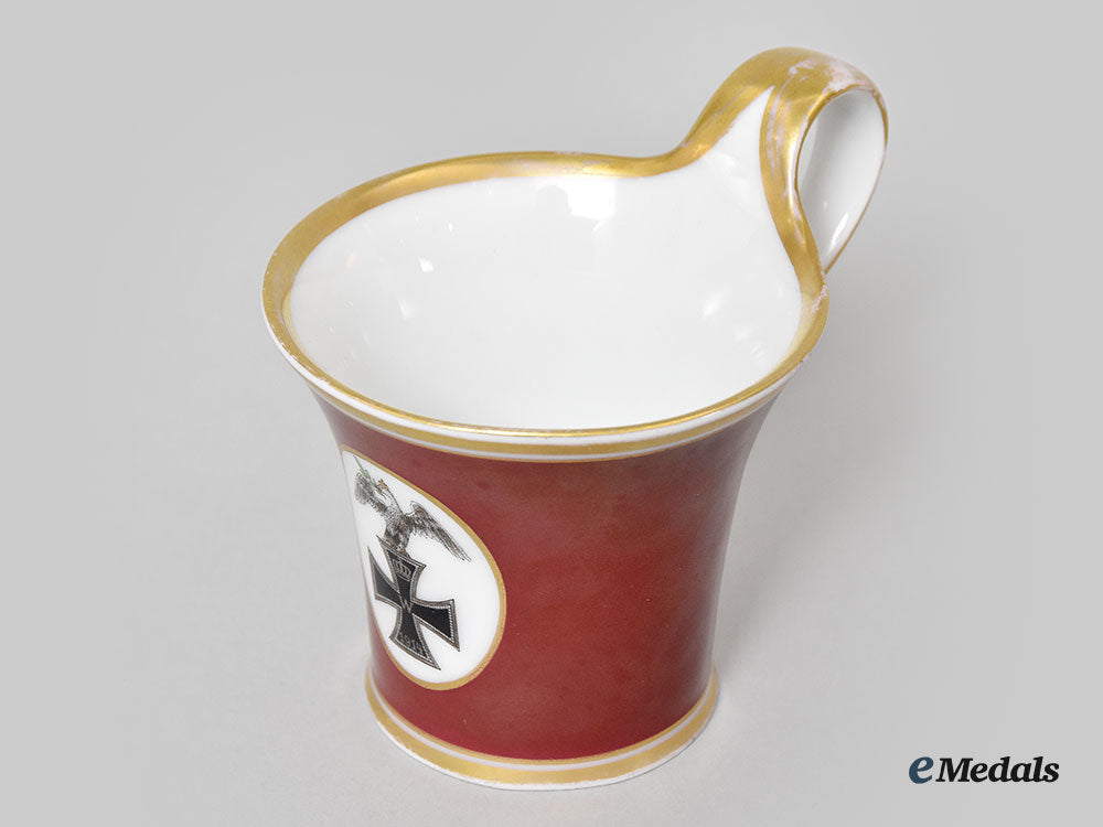 germany,_imperial._a_red_glazed_porcelain_iron_cross_mug,_by_furstenberg_l22_mnc9154_391_1