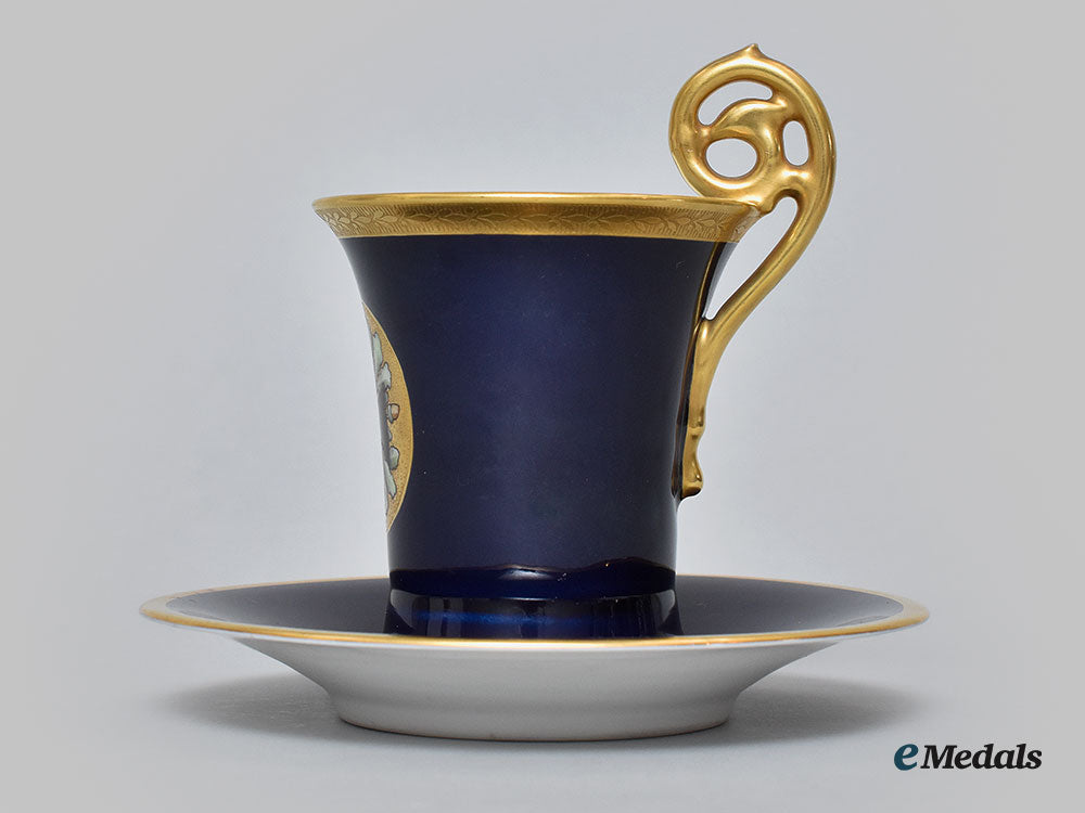 germany,_imperial._a_blue_glazed_teacup_and_saucer_with_iron_cross_depiction,_by_pt_tirschenreuth,_c.1930_l22_mnc9324_639_1
