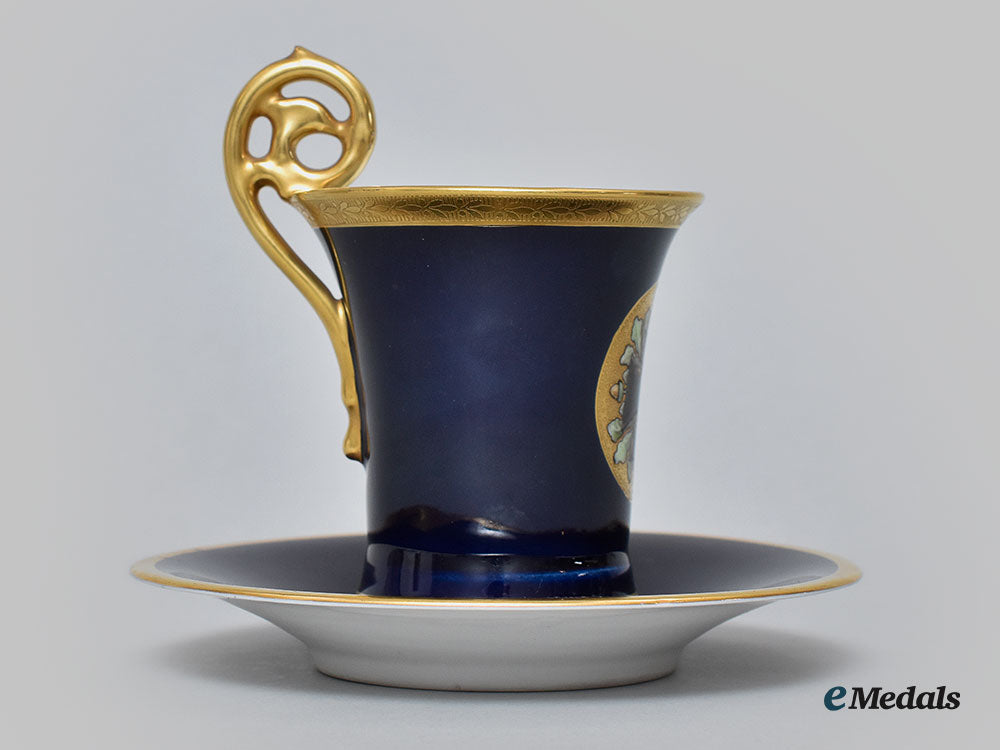 germany,_imperial._a_blue_glazed_teacup_and_saucer_with_iron_cross_depiction,_by_pt_tirschenreuth,_c.1930_l22_mnc9325_638_1