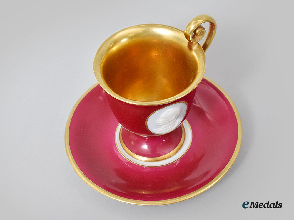 germany,_imperial._a_red_glazed_teacup_and_saucer_with_hindenburg_relief,_by_hutschenreuther,1916_l22_mnc9352_628_1