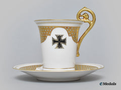 Germany, Imperial. A Decorative Iron Cross Teacup And Saucer With Floral Motifs, By Rosenthal
