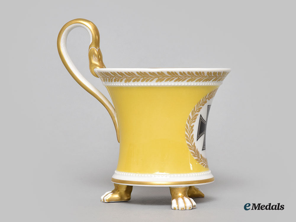 germany,_imperial._a_yellow_glazed_kpm_clawfoot_cup_with_iron_cross_motif_l22_mnc9385_612